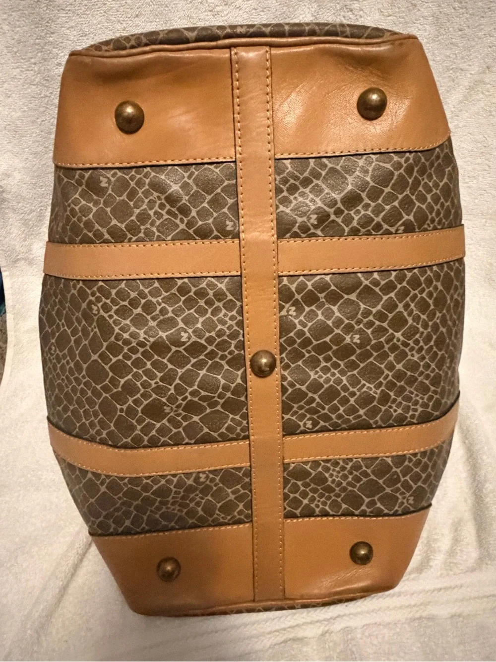 Nina Ricci Brown Patterned Duffel with Tan Trim. Has lock and key.